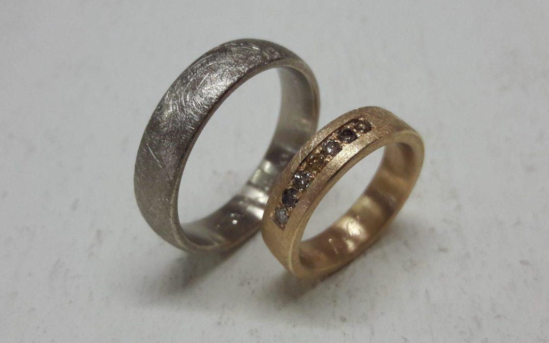 Eismatt zerkratzes Trauringpaar in Weißgold und Roségold mit bunten Brillanten in Reihe gefasst.
